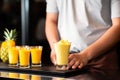 barista serving mango and pineapple smoothies in a cafe Royalty Free Stock Photo