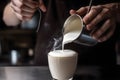 A barista skillfully steaming milk to create velvety microfoam, essential for crafting creamy cappuccinos and lattes. Generative Royalty Free Stock Photo