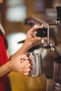 Barista steaming milk at the coffee machine Royalty Free Stock Photo