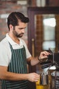 Barista steaming milk at the coffee machine Royalty Free Stock Photo