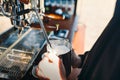 Barista steaming milk in coffee shop