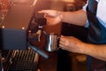 Barista steaming milk in the pitcher with coffee machine for  preparing to make latte art Royalty Free Stock Photo