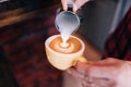 Barista using coffee machine preparing fresh coffee with latte foam at coffee shop and restaurant, bar or bistro Royalty Free Stock Photo