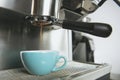 Barista using coffeemaker extraction for espresso shot in cafe