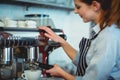 Barista using espresso machine to pour coffee in cup Royalty Free Stock Photo