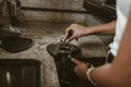 Barista using a tamper to press ground coffee into a portafilter. Coffee maker concept Royalty Free Stock Photo