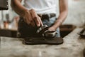 Barista using a tamper to press ground coffee into a portafilter. Coffee maker concept Royalty Free Stock Photo