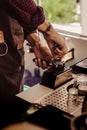 the barista who flattens fine coffee onto the press