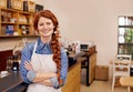 Barista, woman and arms crossed in portrait at cafe with smile, pride and entrepreneurship. Person, waitress or business Royalty Free Stock Photo