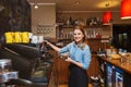 Barista woman making coffee by machine at cafe