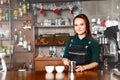 Barista woman at workplace in coffee shop