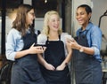 Baristas watching something funny on a phone Royalty Free Stock Photo