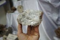 Barite mineral rock stone in hand. a mineral consisting of barium sulfate