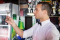 Barkeeper checking a wine glass