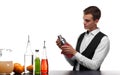 A barkeeper cleaning a capacity for cocktails, isolated on a white background. Barman behind a bar counter with a glass.