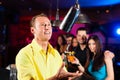 Barkeeper in a pub is mixing cocktails or drinks Royalty Free Stock Photo