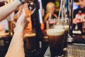 Barkeeper pulling a pint of beer behind the bar. Royalty Free Stock Photo