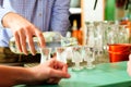 Barkeeper putting hard liquor glasses on bar