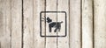 Barking dog silhouette in black color. Barking dog sign on a white wooden background. Guard dog inside icon. Dog Barking