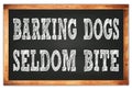 BARKING DOGS SELDOM BITE words on black wooden frame school blackboard