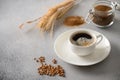 Barley coffee in white cup and ears of barley on gray background. Royalty Free Stock Photo