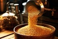 barley grains being poured into a grinder