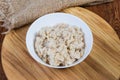 Barley porridge in bowl on the wooden serving board Royalty Free Stock Photo