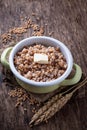 Barley porridge with butter in green pot