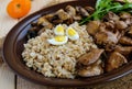 Barley porridge, fried mushrooms and duck liver, boiled quail eggs, tomatoes, arugula - healthy food Royalty Free Stock Photo