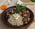 Barley porridge, fried mushrooms and duck liver, boiled quail eggs, tomatoes, arugula - healthy food Royalty Free Stock Photo