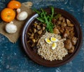 Barley porridge, fried mushrooms and duck liver, boiled quail eggs, tomatoes, arugula - healthy food Royalty Free Stock Photo