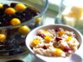 Barley porridge with fruit on a background of cherry plums and cherries in transparent jelly