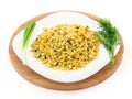 Barley porridge in a plate with vegetables, dill and green onion, selective focus Royalty Free Stock Photo