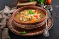 Barley soup with carrots, tomato, celery and meat on a dark backgroundBarley soup with carrots, tomato, celery and meat Royalty Free Stock Photo