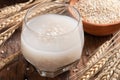 Barley water in glass with raw and cooked