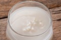 Barley water in glass with raw and cooked