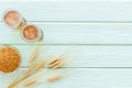 Barley or wheat as beer ingredient near beer glasses on green wooden background top view copy space