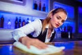 Barmaid cleaning counter