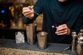 Barman adding blue dye into a shaker making summer cocktail Royalty Free Stock Photo