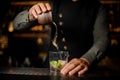 Barman adding a cane sugar into the cocktail glass with lime Royalty Free Stock Photo