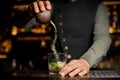 Barman adding cane sugar into the cocktail glass with lime. Process of making Caipirinha cocktail Royalty Free Stock Photo