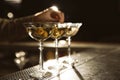 Barman adding olives to martini cocktail on counter. Space for text