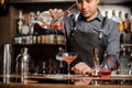 Barman adding red alcoholic drink into the cocktail glass Royalty Free Stock Photo