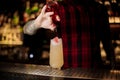 Barman adding sweet red liqueur into a glass with fresh sweet juicy cocktail Royalty Free Stock Photo