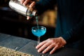 Barman pours an alcohol cocktail from the shaker Royalty Free Stock Photo