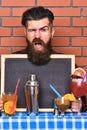 Barman, bartender or hipster holds bar advertising.