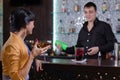 Barman chatting with a female customer Royalty Free Stock Photo