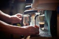 A barman is cleaning an espresso apparatus after using it. Coffee, beverage, bar Royalty Free Stock Photo