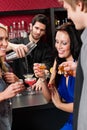 Barman cocktail shaker friends drinking at bar Royalty Free Stock Photo