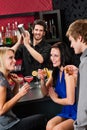 Barman cocktail shaker friends drinking at bar Royalty Free Stock Photo